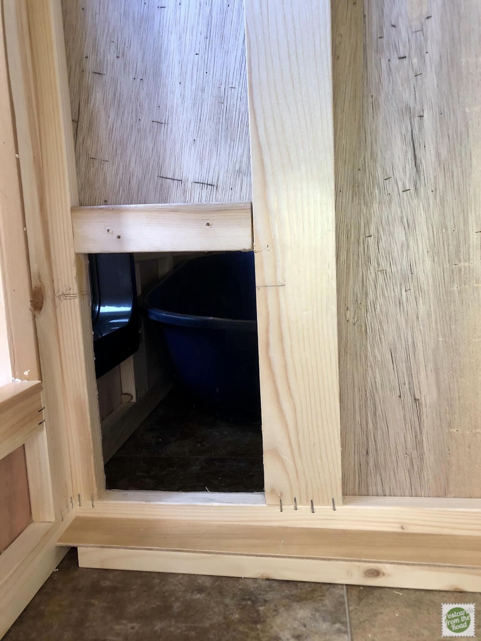 Inside the cabinet looking at the opening cut to the area inder the step.